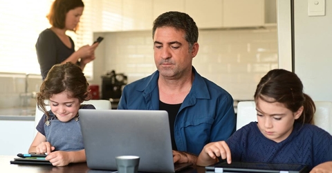Man working from home next to children