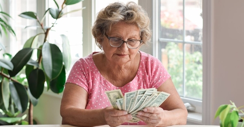 Older woman counting cash