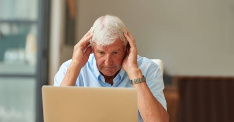 Stressed senior man on laptop
