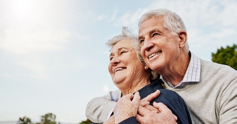 Happy elderly couple hugging