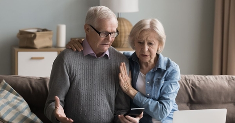 Concerned retired couple on couch 