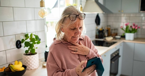 Woman with smartphone looking concerned