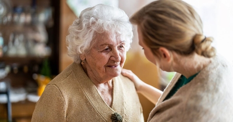 Health visitor talking to a senior woman during home visit