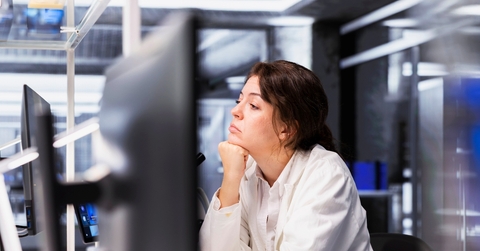 Woman looking bored working in computer lab