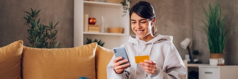 Woman using credit card on cell phone 2
