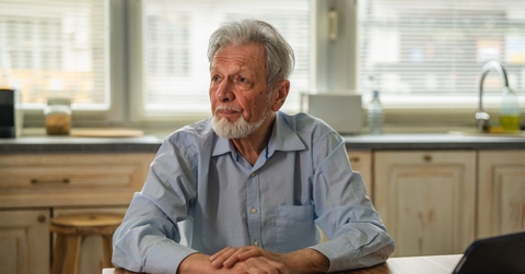Contemplating older man in kitchen 
