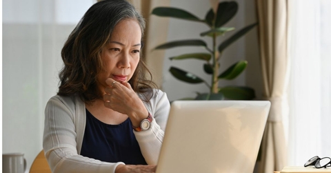 Older woman at home on laptop
