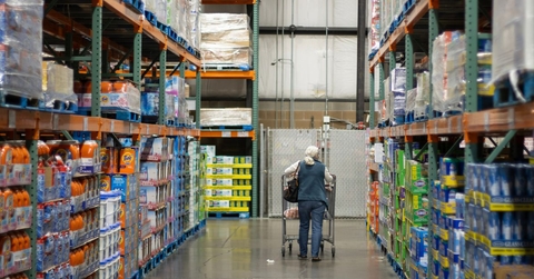 Older woman shopping down a Costco aisle