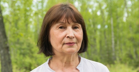 Portrait of one woman 50 years old in a summer forest 
