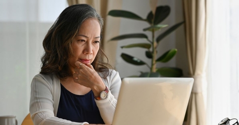 Mature woman on laptop in dining room