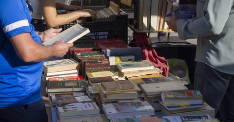People looking for a book in a vintage market
