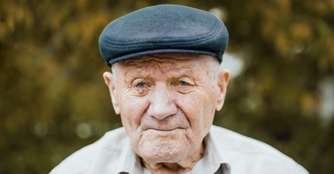 Portrait of an elderly man wearing a cap