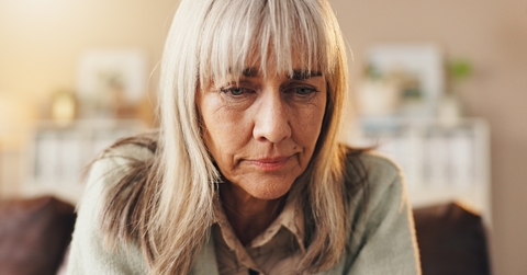 Older woman looking down sad