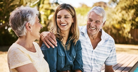 Senior parents smiling with adult daughter