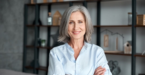 Mature woman smiling with arms crossed