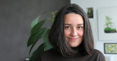 Woman in her 40s smiling at camera