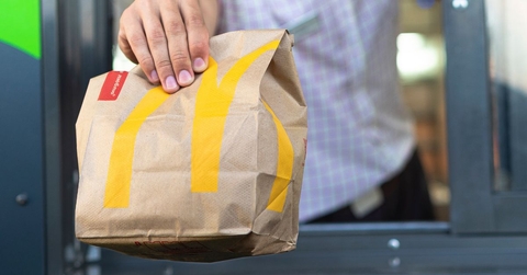 McDonald's bag being handed through the drive thru window