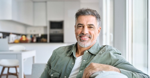 Smiling mature man in a green shirt