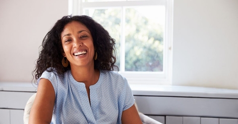 Smiling woman in her 40s with a blue top
