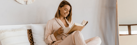 Woman drinking coffee in luxurious bedroom
