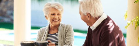 Older couple enjoying breakfast on their patio