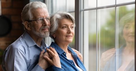 Senior couple looking through the window