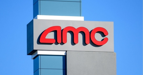 AMC sign, logo advertises AMC movie theater on a sunny day under blue sky 