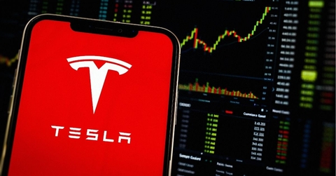 Smartphone Displays Tesla Logo (TSLA Shares) Stock Market Chart