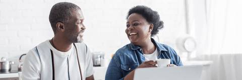 Retired couple on laptop reviewing expenses