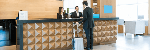 Man checking into hotel at front desk