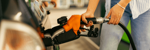 Woman filling up car at gas pump