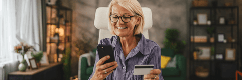 Woman in her 50's with credit card online shopping