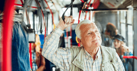 Senior man riding public bus