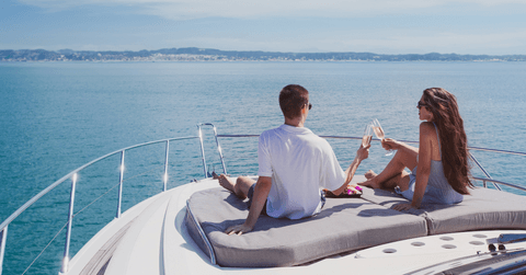 Wealthy couple drinking champagne on yacht