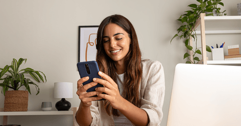 Woman checking CD rates on phone