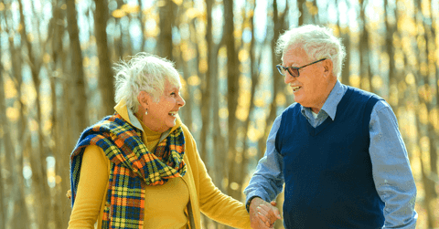 Couple in their 80s on a walk in autumn