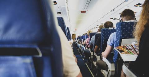 Passengers sitting in airplane seats