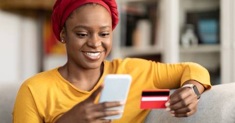 An adult woman using a credit card