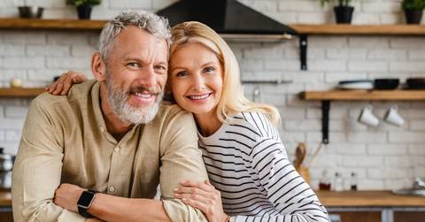 Middle-aged couple smiling at the camera