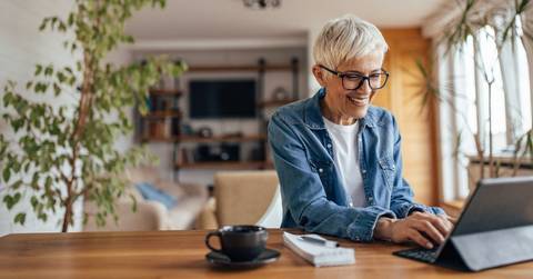 Smiling woman using computer