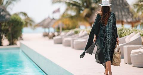 woman walking by the pool in a luxury hotel resort