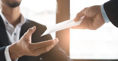office worker receiving extra money from boss as a reward 