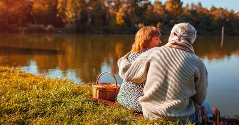 Senior couple sitting by lake