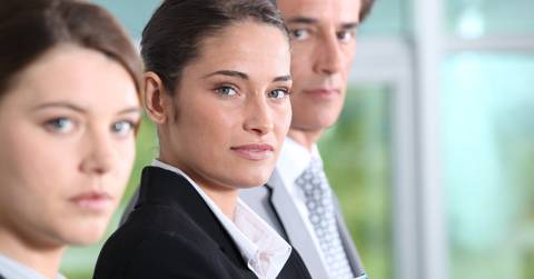 office employees standing in line holding documents