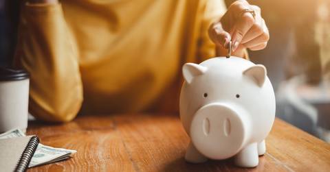 put money coin into piggy
