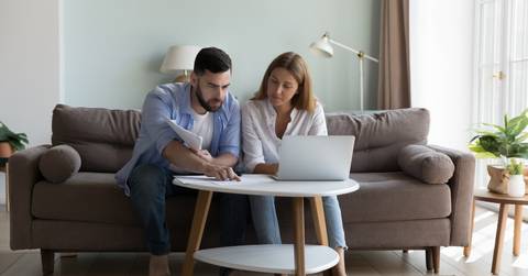 Young Couple reviewing bills at home 