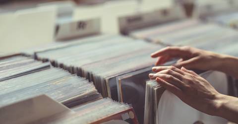 womens hands browsing vinyl records