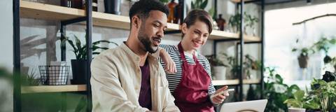 shop assitants using laptop at work