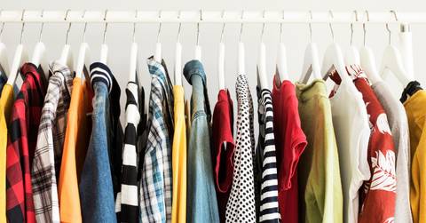 Collection of clothes hanging on rack