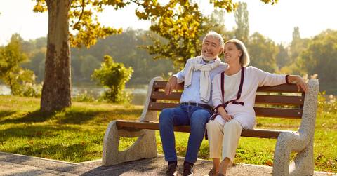 senior couple relaxing on outdoor bench